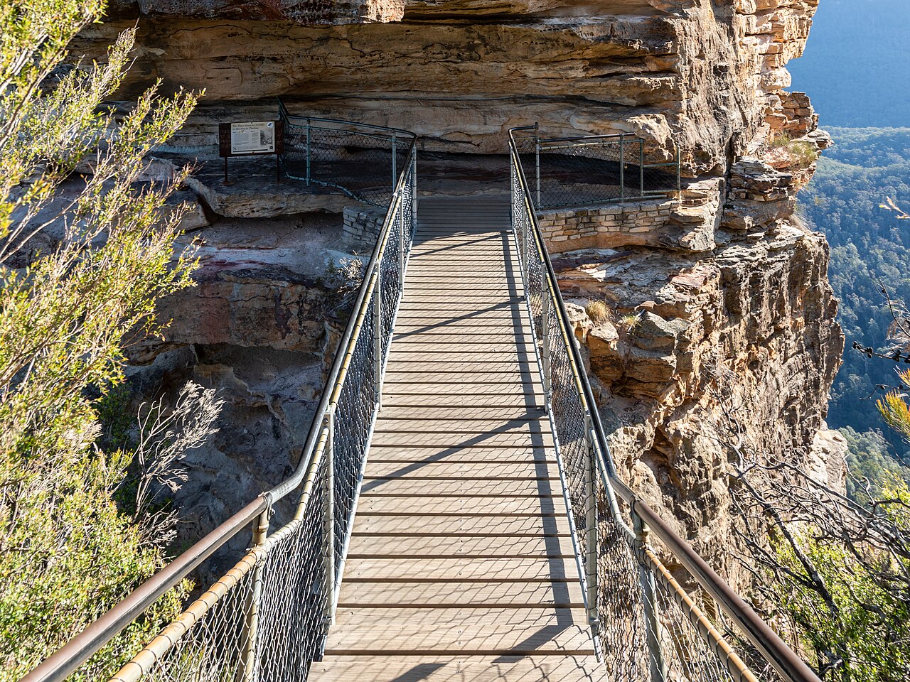 Dramatic sandstone rock formation rising above the valley at sunrise